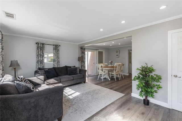 living room featuring ornamental molding and dark hardwood / wood-style flooring