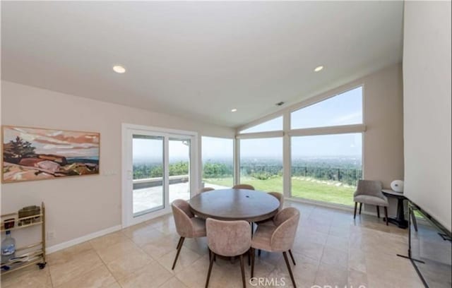 tiled dining area with lofted ceiling