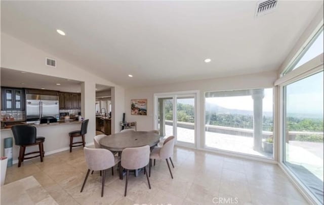 dining area featuring vaulted ceiling