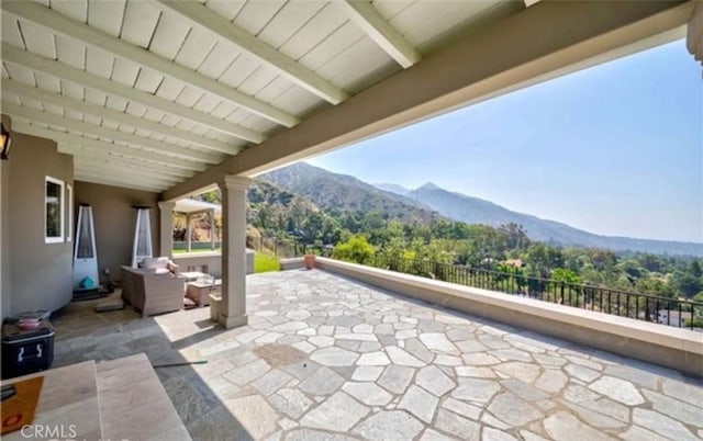 view of patio / terrace with a mountain view and an outdoor hangout area