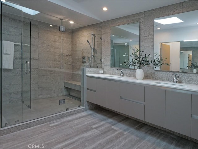 bathroom featuring vanity, hardwood / wood-style floors, and walk in shower