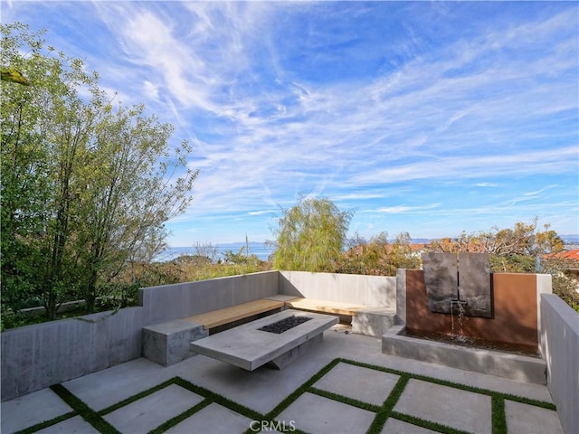 view of patio featuring an outdoor fire pit