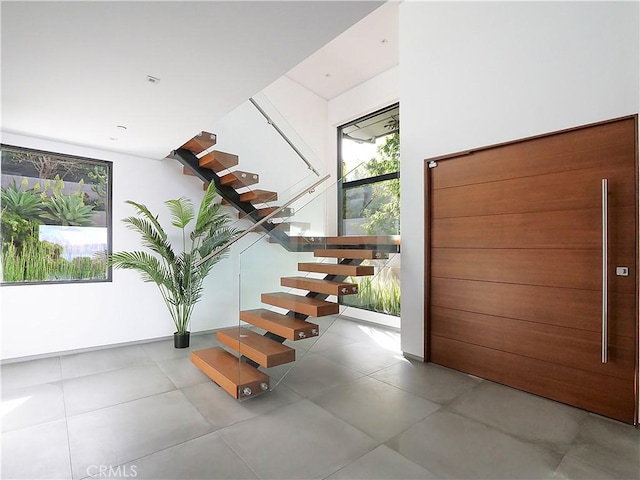 stairs featuring concrete flooring