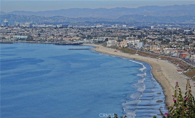 bird's eye view featuring a water and mountain view and a view of the beach