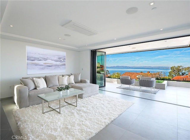 living room featuring expansive windows and a water view