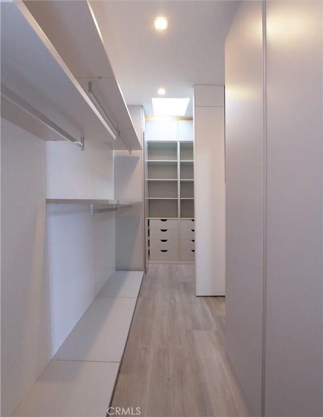 walk in closet featuring light hardwood / wood-style flooring