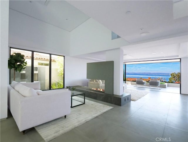 living room with concrete flooring and plenty of natural light