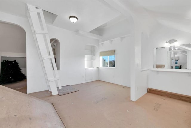 spare room with lofted ceiling