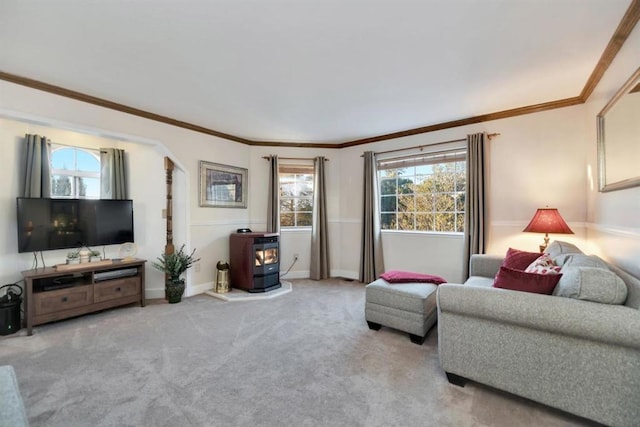 carpeted living room with crown molding and a wood stove