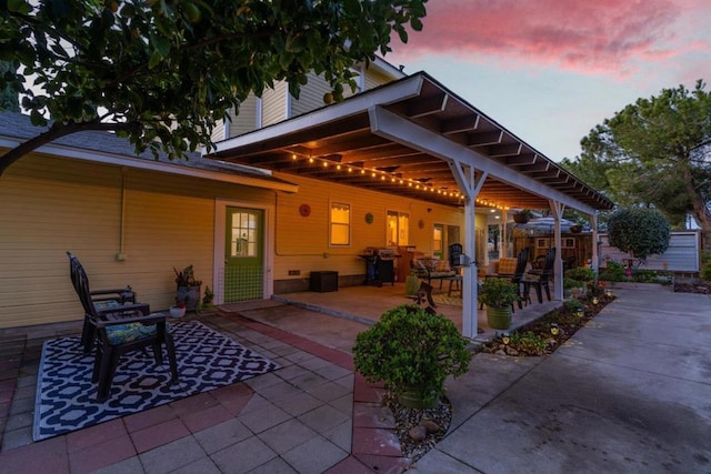 view of patio terrace at dusk