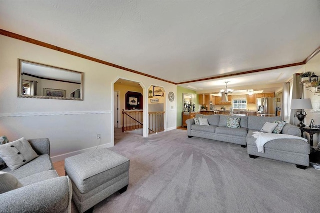 living room featuring a notable chandelier, crown molding, and light colored carpet