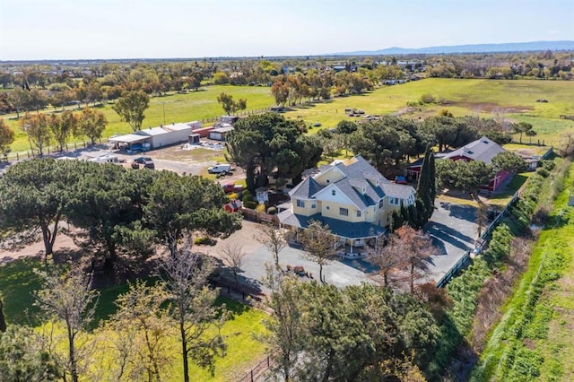 birds eye view of property with a rural view