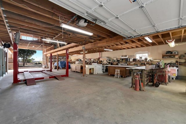 garage with a garage door opener and a workshop area