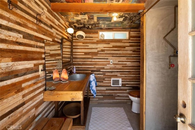 wine room featuring sink and wood walls