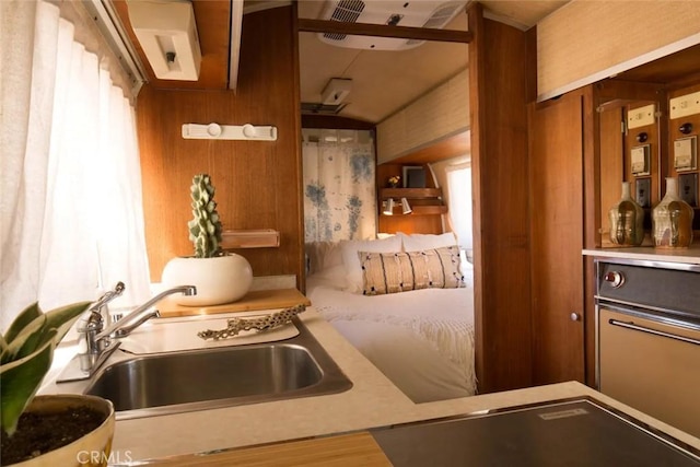 kitchen with wooden walls and sink