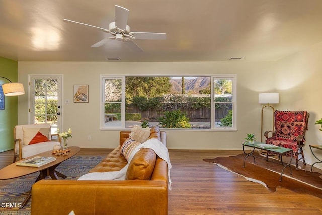 living room featuring hardwood / wood-style flooring, plenty of natural light, and ceiling fan