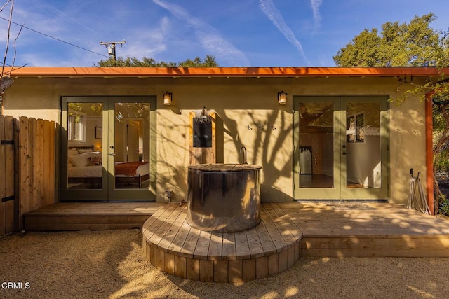 rear view of house featuring french doors and a deck