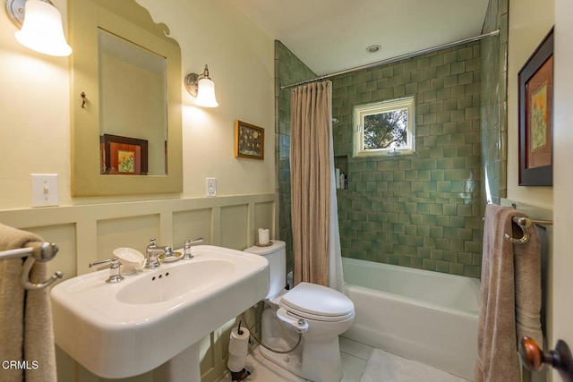 full bathroom with shower / bath combination with curtain, tile patterned floors, toilet, and sink