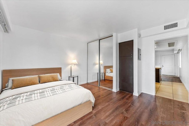 bedroom with dark hardwood / wood-style flooring