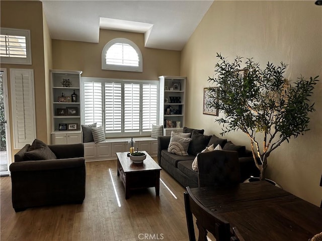 living room with hardwood / wood-style flooring and vaulted ceiling