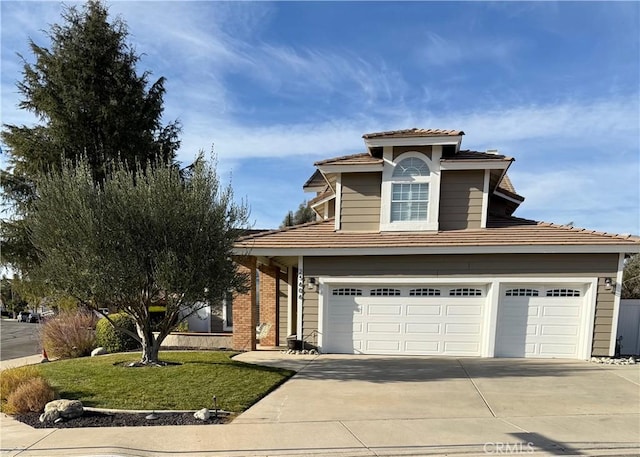 view of front facade with a garage and a front lawn