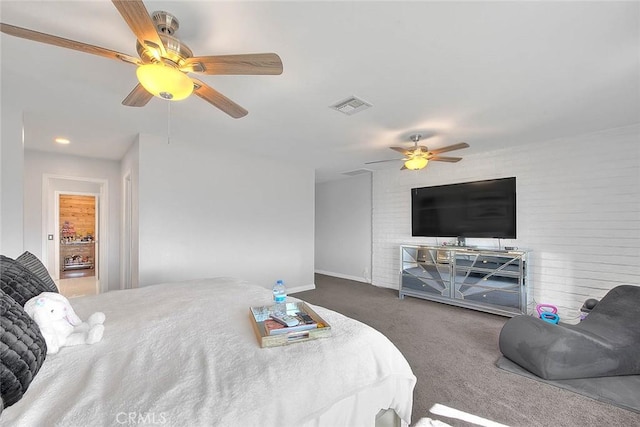 carpeted bedroom featuring brick wall and ceiling fan