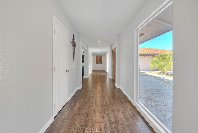 corridor featuring dark wood-type flooring