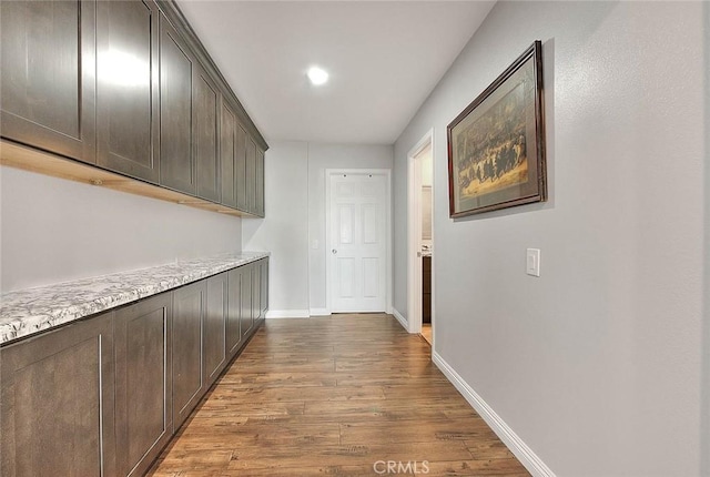 hallway with light hardwood / wood-style flooring