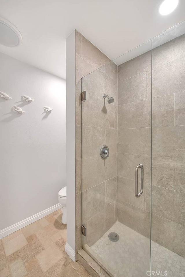 bathroom with walk in shower and toilet