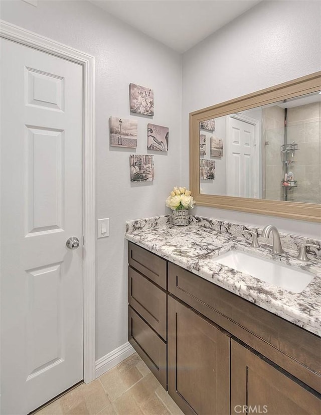 bathroom with vanity and tiled shower