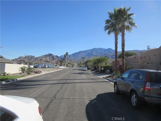 view of street with curbs and a mountain view