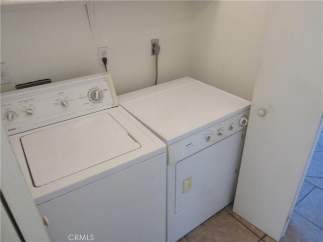 laundry area with light tile patterned flooring, laundry area, and independent washer and dryer