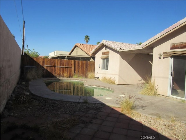 view of yard featuring a fenced in pool, a patio, and a fenced backyard