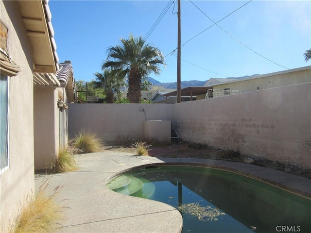 view of pool featuring a patio area and a fenced backyard