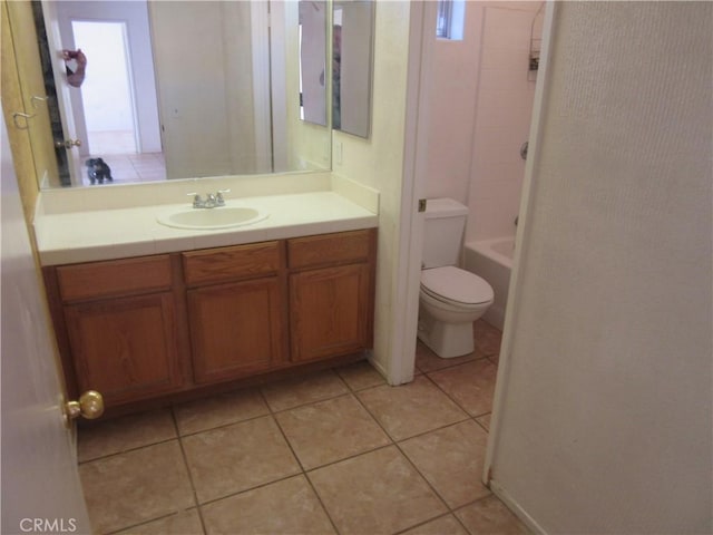 bathroom featuring tile patterned flooring, toilet, and vanity