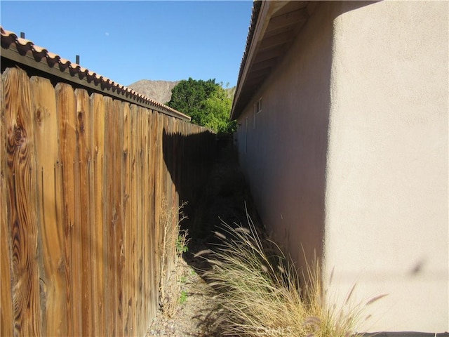 view of home's exterior featuring stucco siding and fence