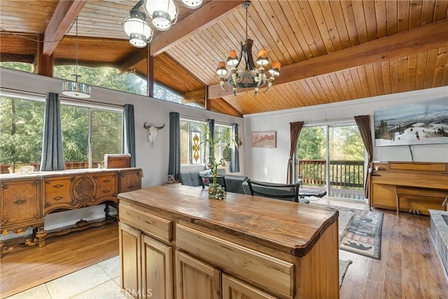 sunroom with wood ceiling, a chandelier, and lofted ceiling with beams