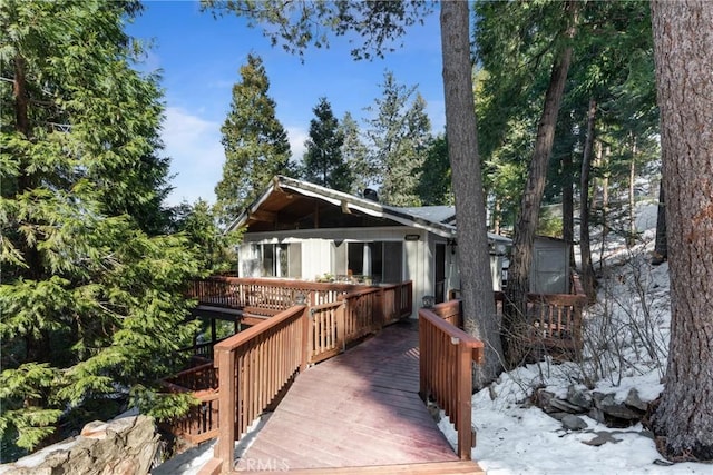 rear view of property featuring a deck