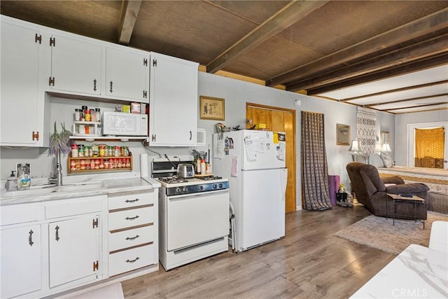 kitchen with sink, light hardwood / wood-style flooring, white appliances, beam ceiling, and white cabinets