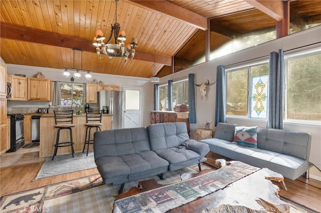 living room with wooden ceiling, vaulted ceiling with beams, a notable chandelier, and light hardwood / wood-style floors