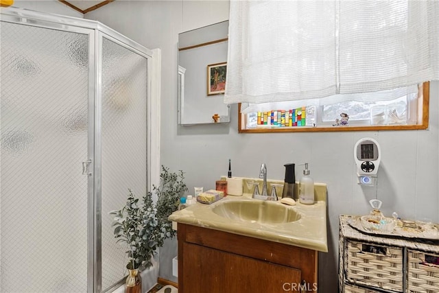 bathroom featuring vanity and a shower with shower door