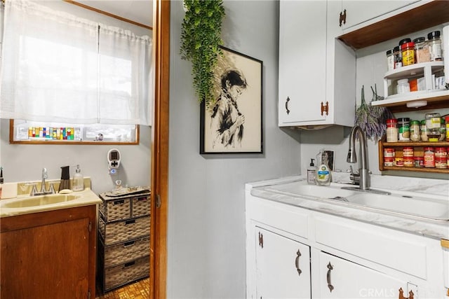 bar featuring white cabinetry and sink