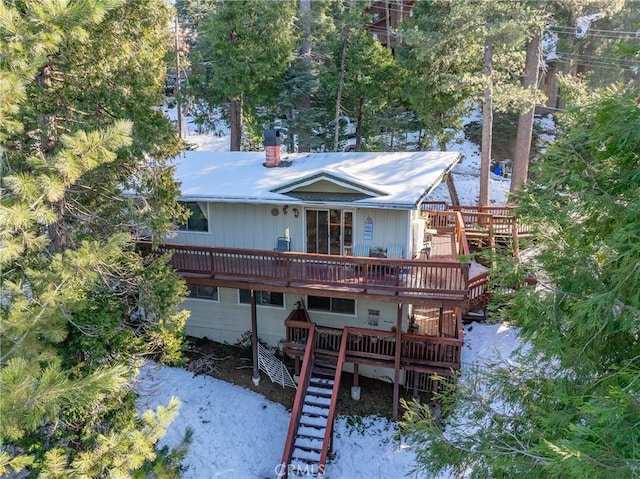 rear view of property featuring a deck