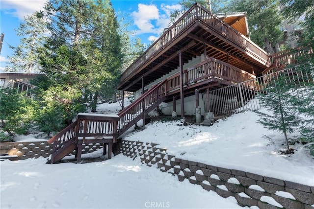 view of snow covered exterior featuring a deck