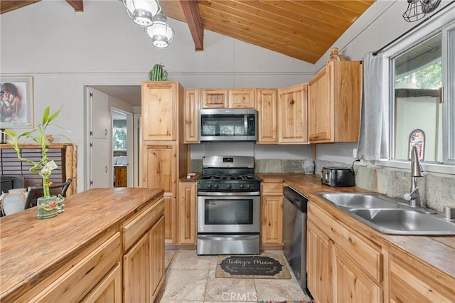 kitchen with a wealth of natural light, lofted ceiling with beams, sink, stainless steel appliances, and light brown cabinets