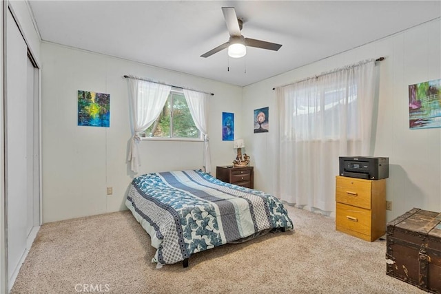 bedroom with light colored carpet, a closet, and ceiling fan