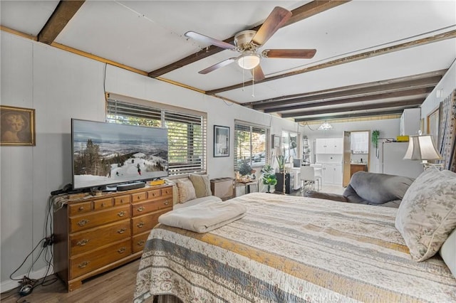 bedroom with wood-type flooring, ceiling fan, and beam ceiling