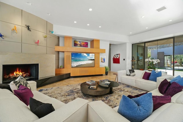 living room featuring tile patterned floors and a tile fireplace