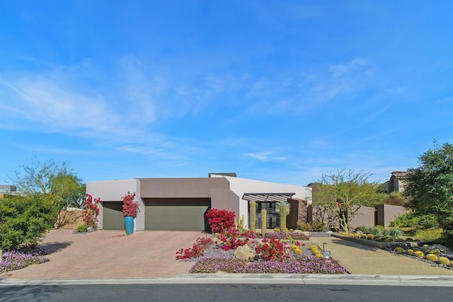 pueblo-style home with a garage