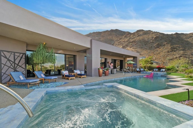 view of swimming pool featuring a mountain view and a patio